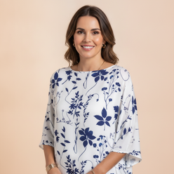 Portrait of Amelia Thorne, a woman with a warm smile, looking confidently at the camera against a soft cream background with 