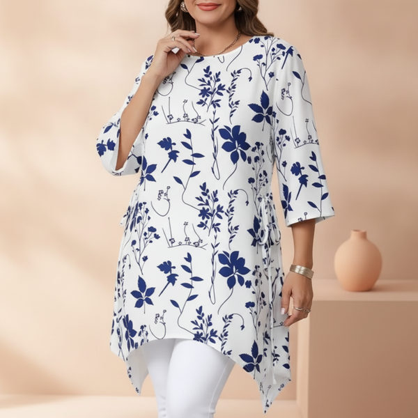 Close-up of a woman in the AURELIA dress, highlighting the adjustable waist and flowing silhouette against a warm, soft backg